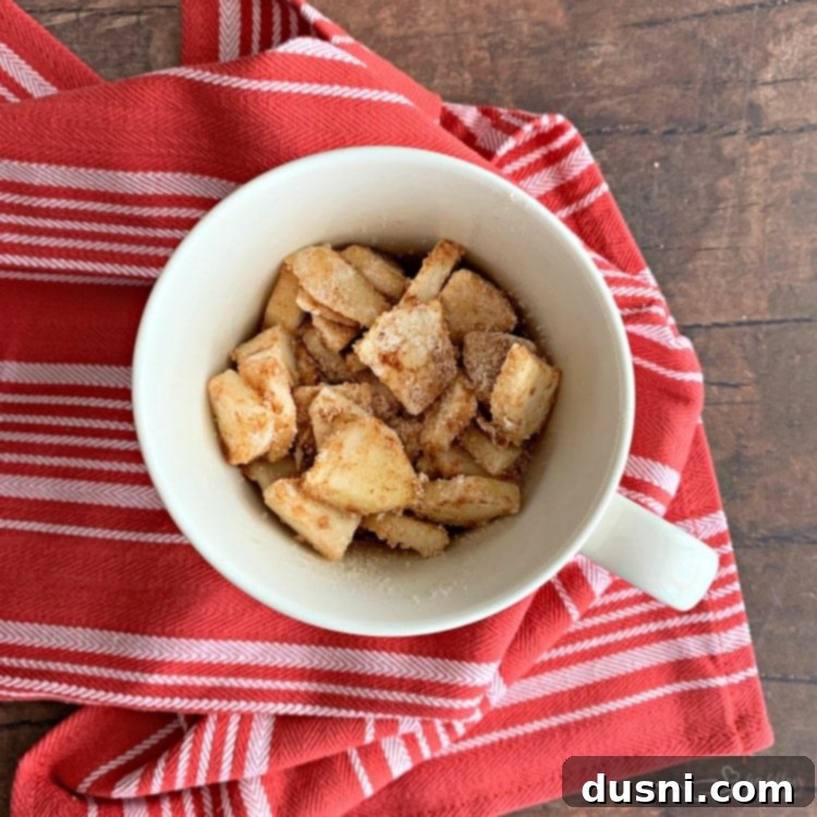 Diced apples tossed with cinnamon, sugar, and flour, placed into the prepared mug