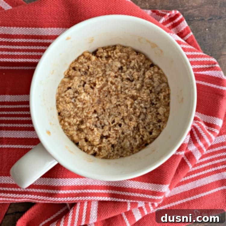 Microwaved Apple Crisp in a Mug, showing a bubbly, cooked topping