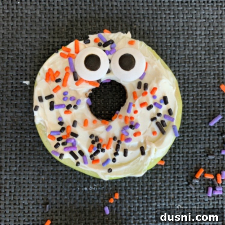 Apple Donut Monster with sprinkles and eyes