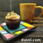 Coffee Cloud Frosting 2 Side view of a cup cake plated and a cup of coffee with text "coffee buttercream frosting"