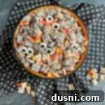 Overhead of Halloween Double Peanut Butter Muddy Buddies in a halloween bowl