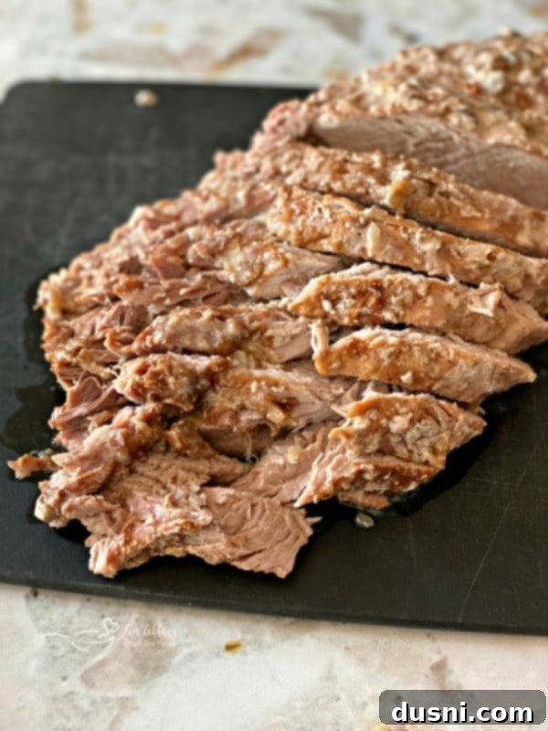 Sliced Fuggedaboutit Pork Roast on a cutting board