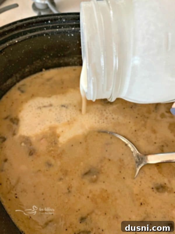 Gravy from pork roast being prepared in a roasting pan