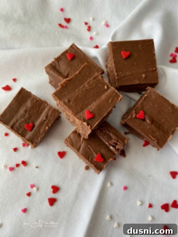 Never Fail Fudge decorated with romantic sprinkles for Valentine's Day, a sweet gift idea.