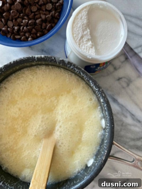 Marshmallow creme and chocolate chips laid out, ready to be added to the hot fudge mixture.