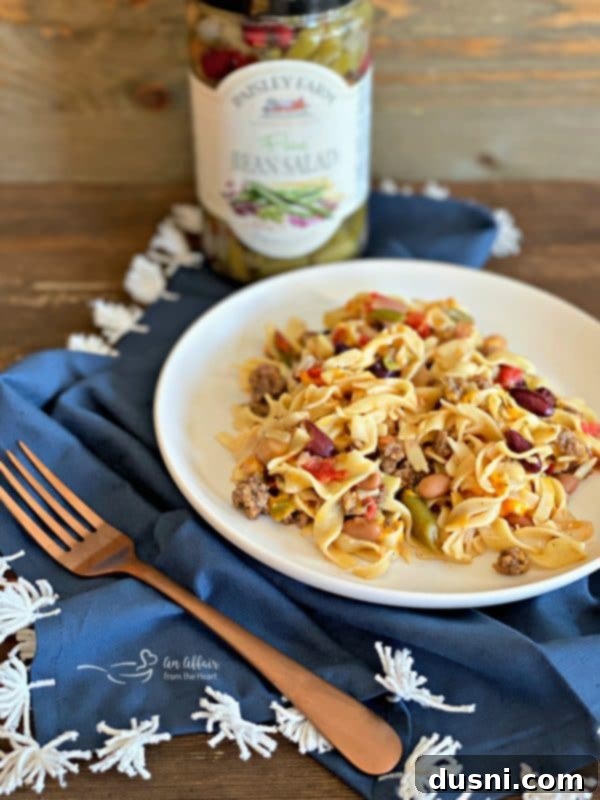 Five Bean Ground Beef & Noodle Skillet Casserole cooking in a pan