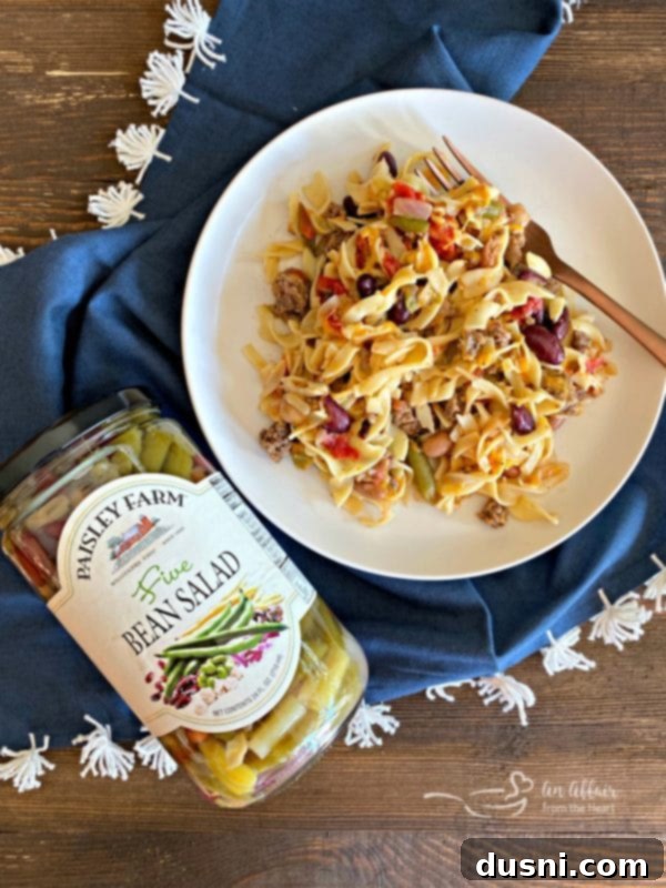 Serving the Paisley Farm Five Bean Ground Beef & Noodle Skillet Casserole directly from the pan