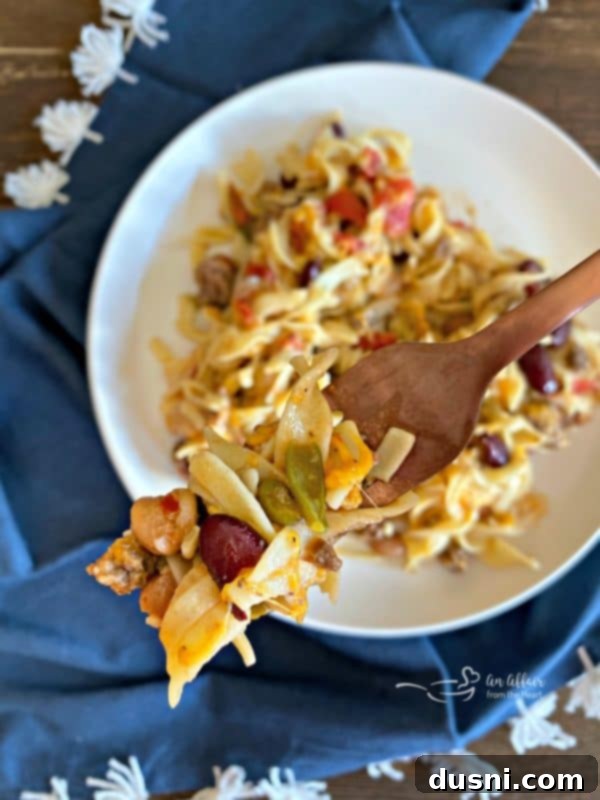 A spoonful of Five Bean Ground Beef & Noodle Skillet Casserole ready to eat