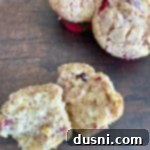 Overhead of Cranberry Orange Muffins. One cut in half