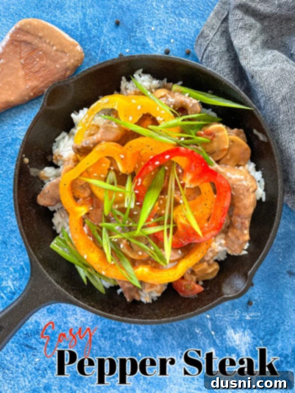 A graphic illustrating the finished pepper steak in a cast iron skillet, perfect for sharing and easy weeknight cooking.