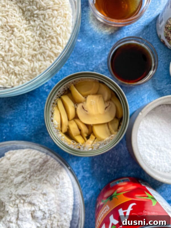 A selection of key ingredients for pepper steak, including fresh mushrooms, various spices, and other essential items, laid out on a clean surface.
