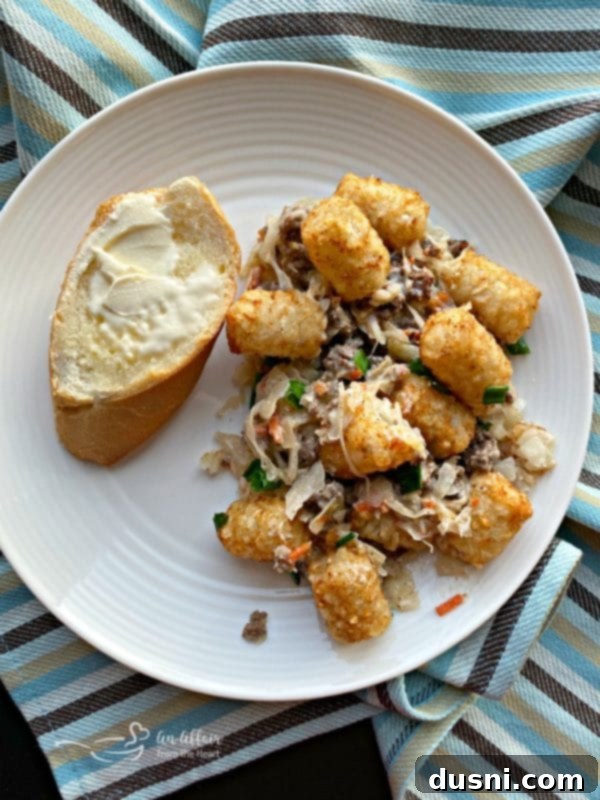 Serving of Beef & Kraut Tater Tot Casserole with a fork.