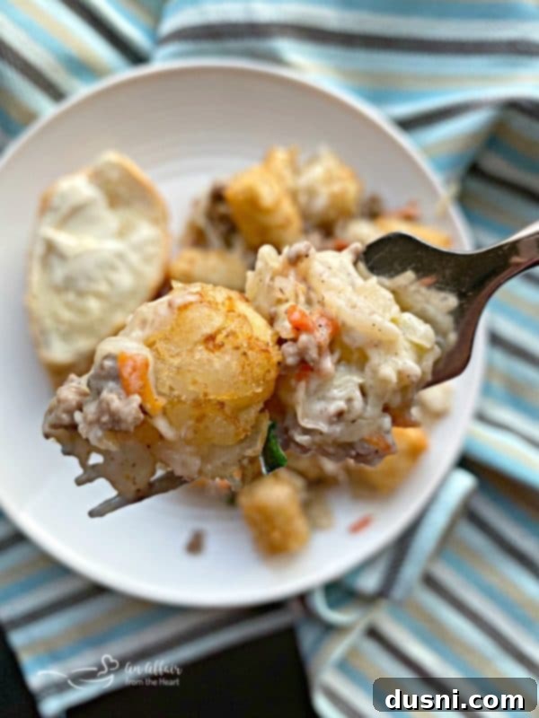 Close-up of a bite of Beef & Kraut Tater Tot Casserole.