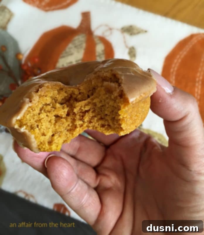 Glazed Baked Pumpkin Donuts, perfectly golden and covered in a sweet glaze, a delightful treat for any season.