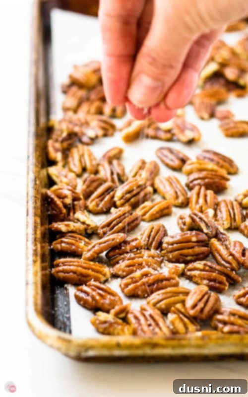 A bowl of beautifully buttered and toasted pecans, ready to be used in various recipes or enjoyed as a snack.