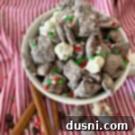 Aztec Hot Cocoa Medley 14 Mexican Hot Chocolate Chex Mix with sprinkles in a white bowl, ready to serve.