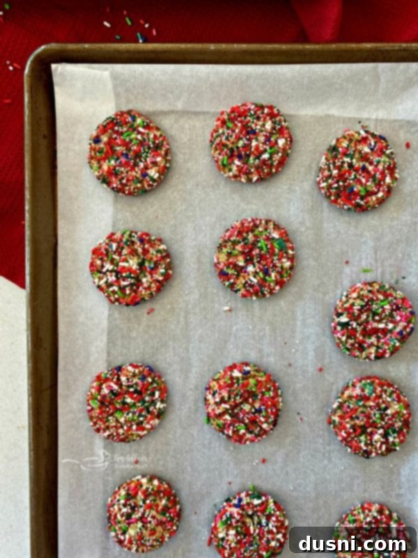 Festive Funfetti Sugar Cookies 15 Freshly baked Funfetti Sugar Cookies cooling on a parchment-lined baking sheet