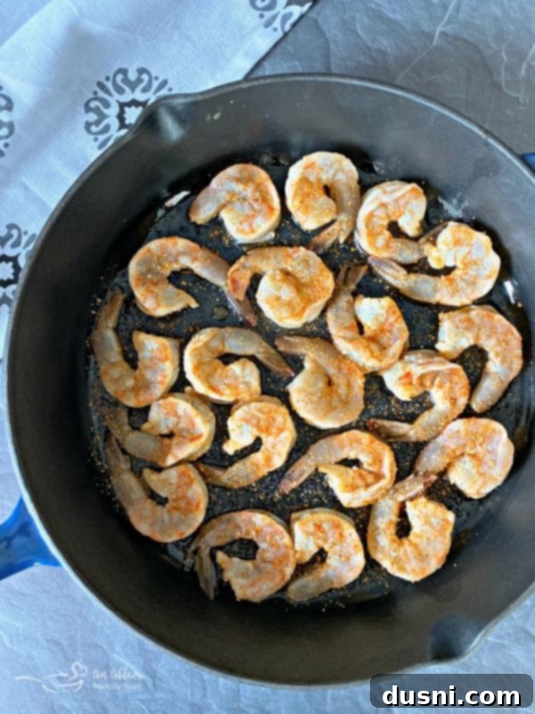 Spicy Caribbean Shrimp cooking in a cast iron skillet