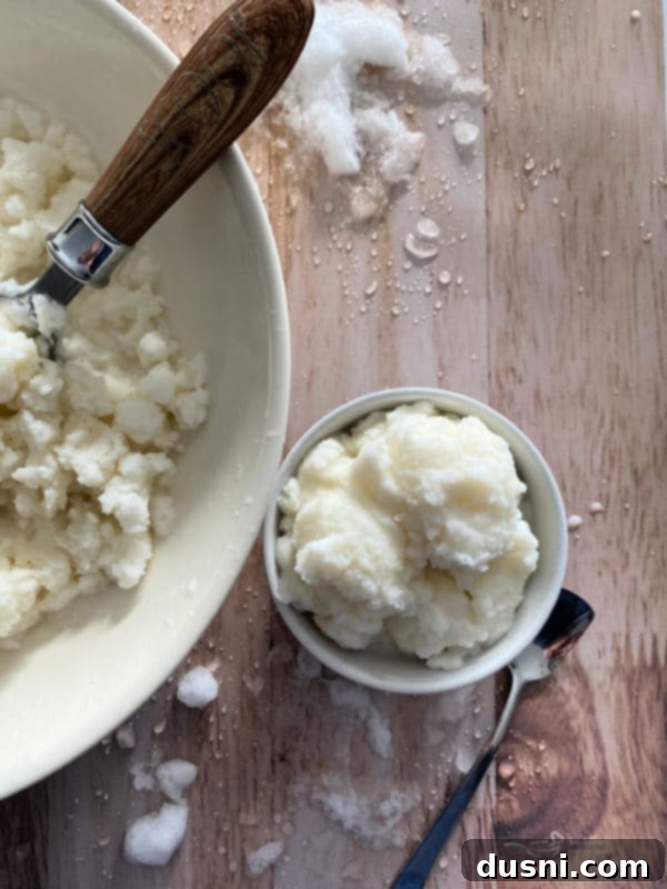 A bowl of freshly made snow ice cream, fluffy and white, ready to be served.
