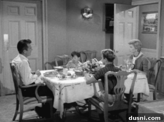 The Cleaver Family enjoying a meal, depicting a classic and ideal family dinner scene from the past.