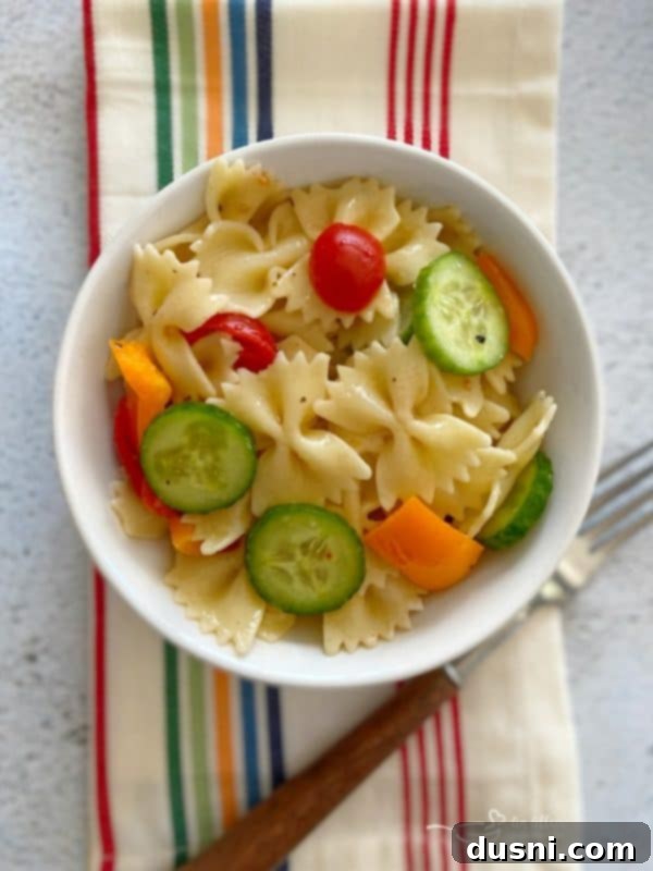 Easy French Vinaigrette Pasta Salad in a small bowl on a napkin