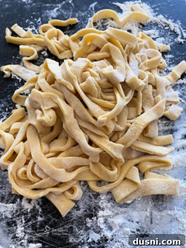 Raw homemade egg noodle dough being prepared