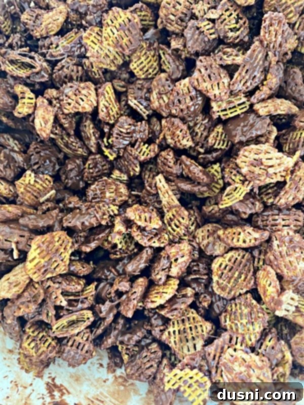 Melted milk chocolate being poured over Crispix cereal