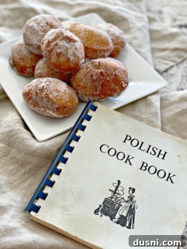 Pączki - Polish Donuts on a white plate and Polish Cookbook