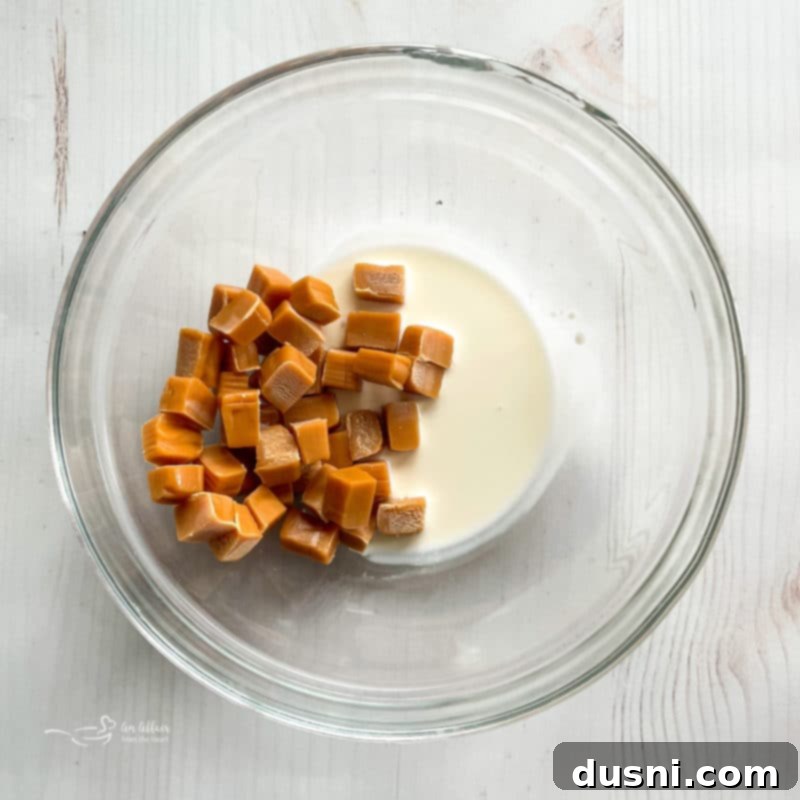 Step 5: Adding mini marshmallows and peanut butter cups to the Chex mix.