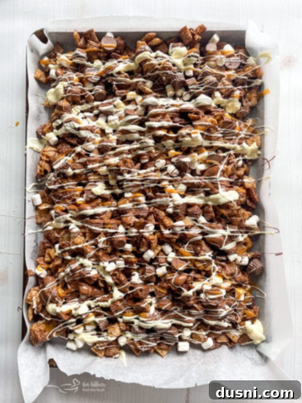 Step 6: Drizzling caramel over the Chex mix.