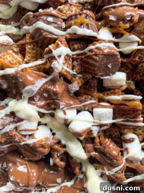 Step 6 (continued): Drizzling melted white chocolate over the Chex mix.