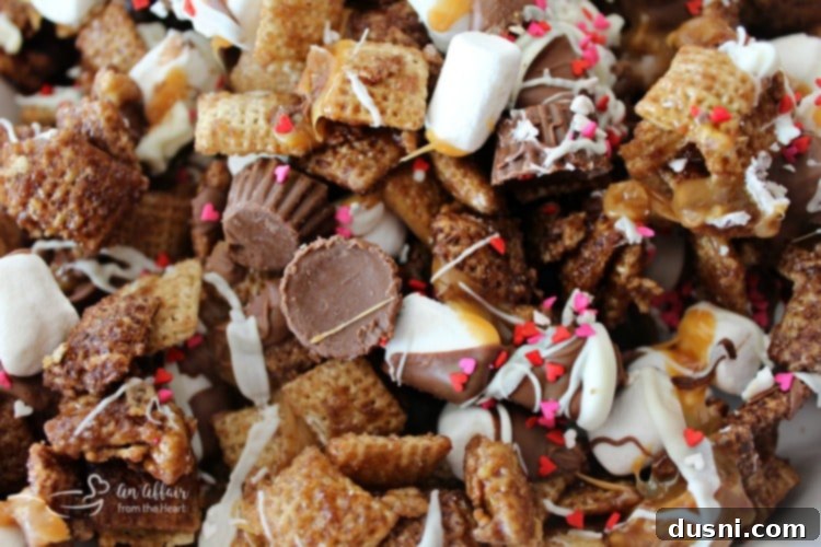 Better Than Sex Chex Mix in a heart-shaped bowl, ready to serve.