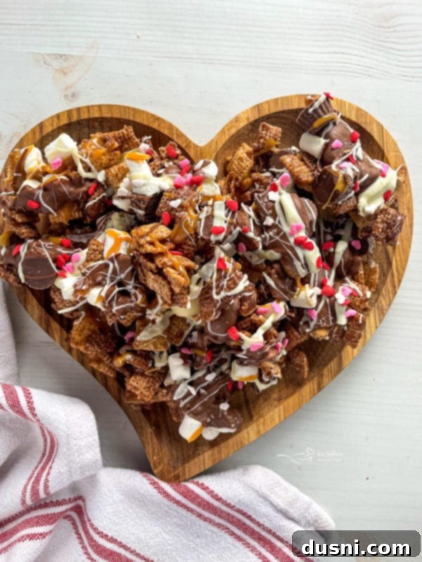 Close-up of Better Than Sex Chex Mix with melted chocolate and caramel drizzle.