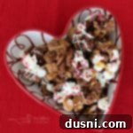 overhead of Better Than Sex Chex Mix in a heart shaped bowl