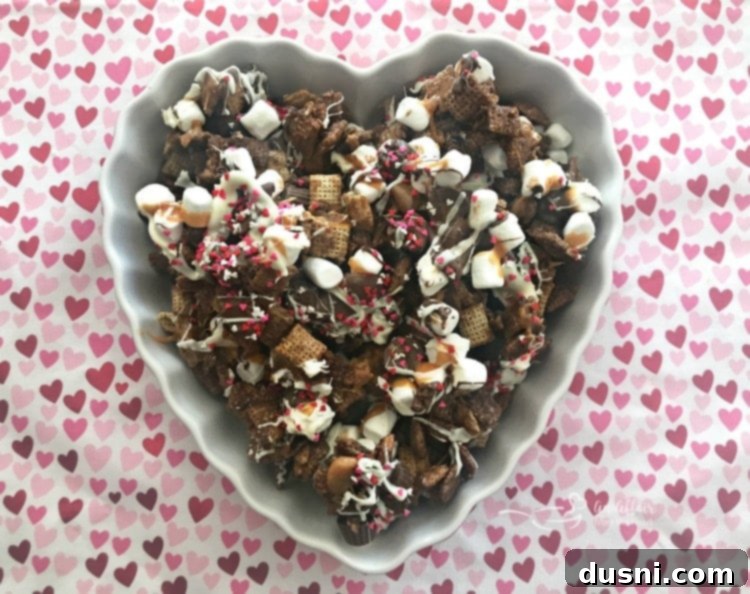 Better Than Sex Chex Mix spread on a baking sheet, showcasing all the ingredients.