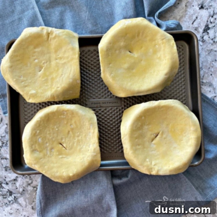 Reuben Pot Pies topped with puff pastry, ready for baking.