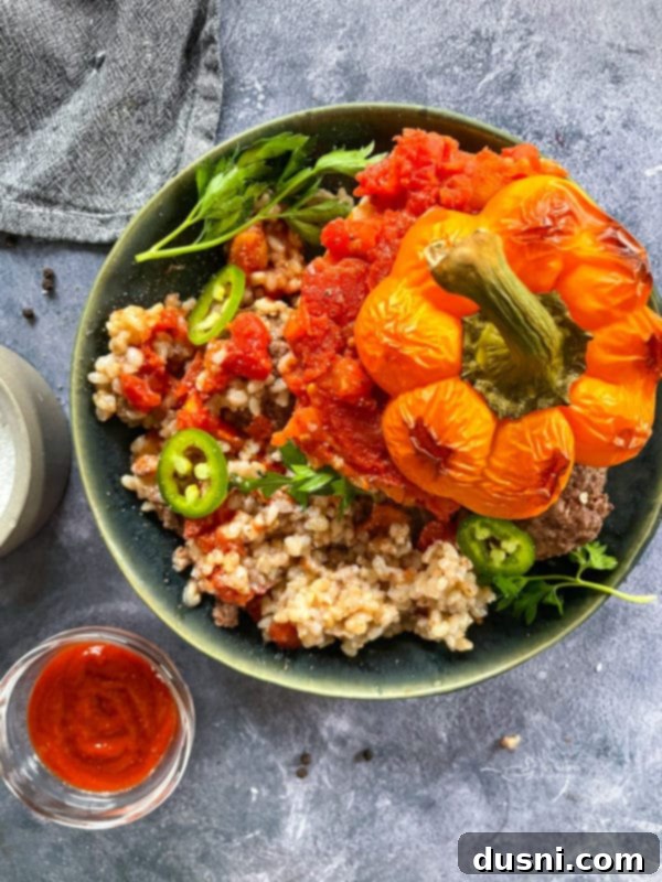 Top view of a stuffed pepper half, beautifully presented over rice.