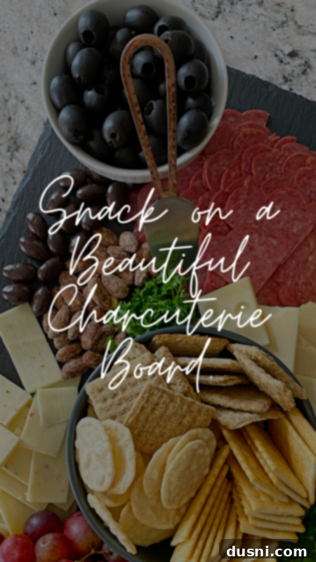 Gourmet charcuterie board with cheeses, meats, and fruits