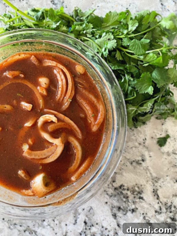 Fiesta Pork Chops 7 Adding sliced onion to tomato sauce with spices