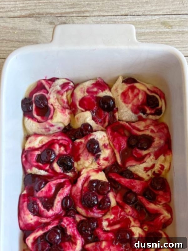 Sunshine Lemon Blueberry Rolls 10 Sweet rolls placed in a baking pan, ready to rise