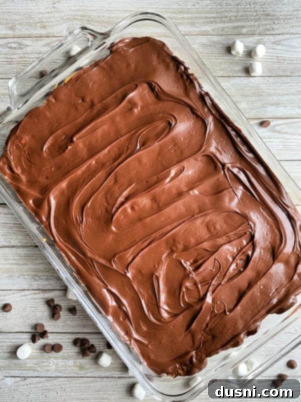 Pantry Perfection Bars 6 Whatchamacallit Bars being frosted with melted chocolate