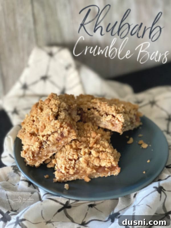 Sweet-Tart Rhubarb Crumble Bars 13 Several Rhubarb Crumble Bars stacked on a plate