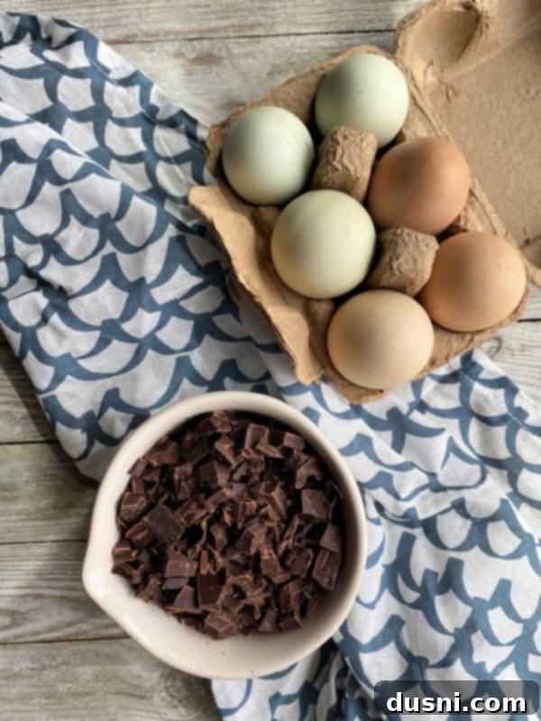 A bowl of farm-fresh brown eggs with rich, orange yolks, ready to be used in baking.
