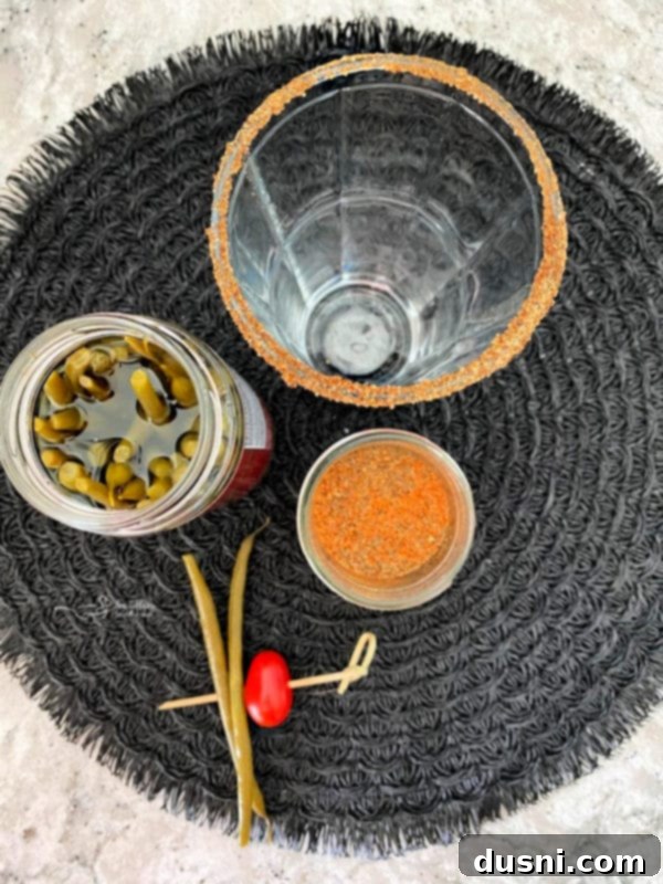 A beer glass being dipped into a spice blend to create a rim, the first step in preparing a Kicked Up Red Beer.