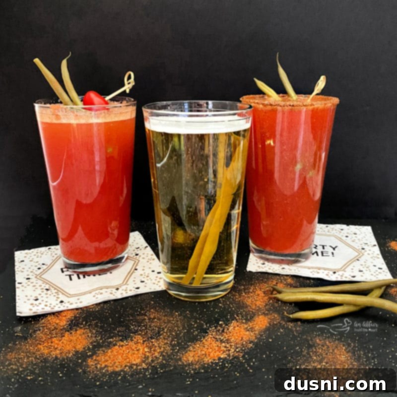 A Kicked Up Red Beer expertly garnished with a skewer of Ely Farms pickled green beans and a cherry tomato, ready to be enjoyed.