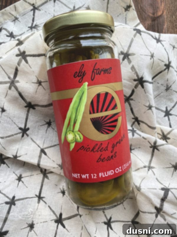 A jar of Ely Farms Pickled Green Beans, showcasing the vibrant green color and fresh appearance of the local Nebraska produce.