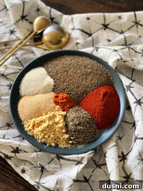 Ingredients for the homemade Bloody Mary Dry Spice blend laid out on a surface, including celery salt, paprika, and cayenne pepper.