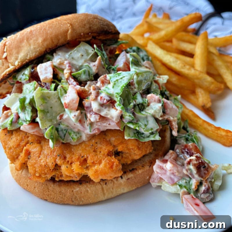 Blackened Salmon Patties and Zesty BLT Slaw 11 A freshly grilled blackened salmon burger with BLT slaw on a plate