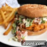 Blackened Salmon Patties and Zesty BLT Slaw 17 Blackened Salmon Burgers with BLT Slaw with fries on white plate