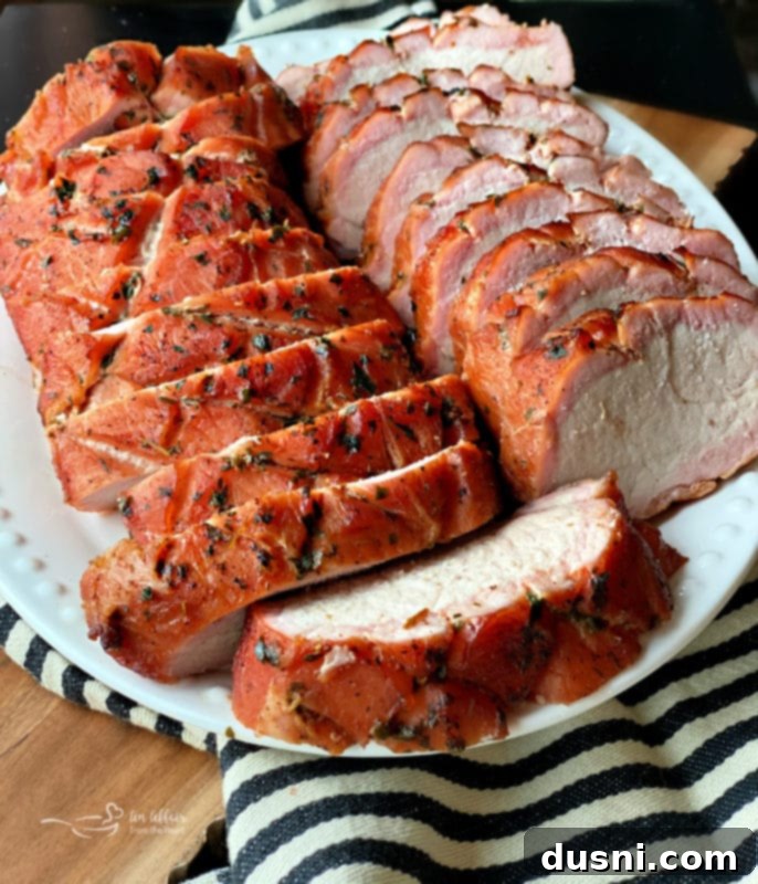 sliced pork loin on a plate with greens